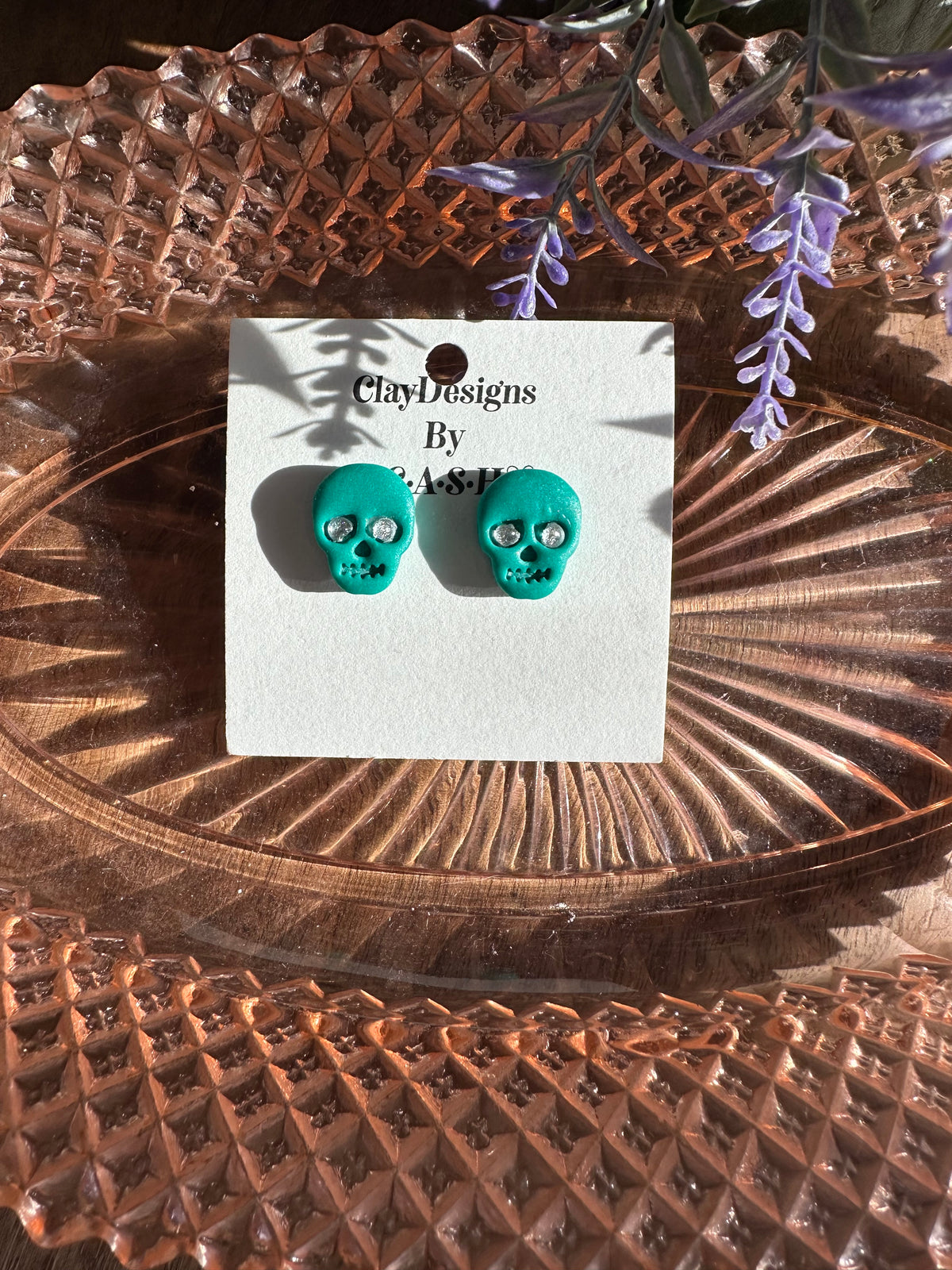 Green/teal diamond skull studs
