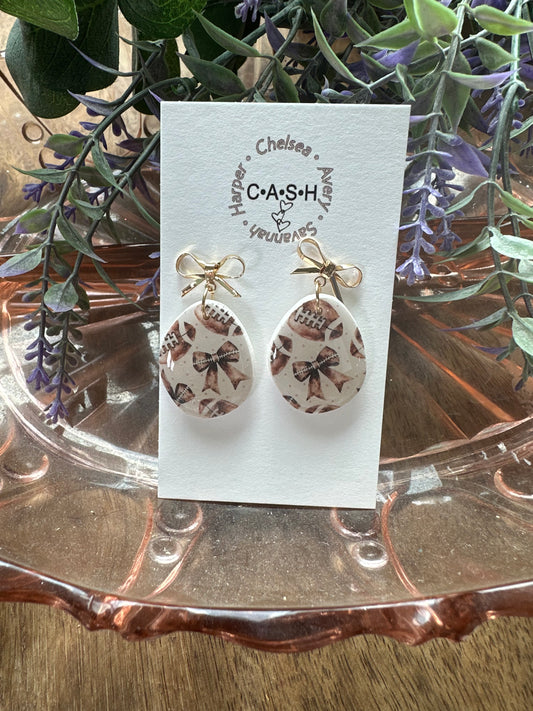 Football with gold bow dangles