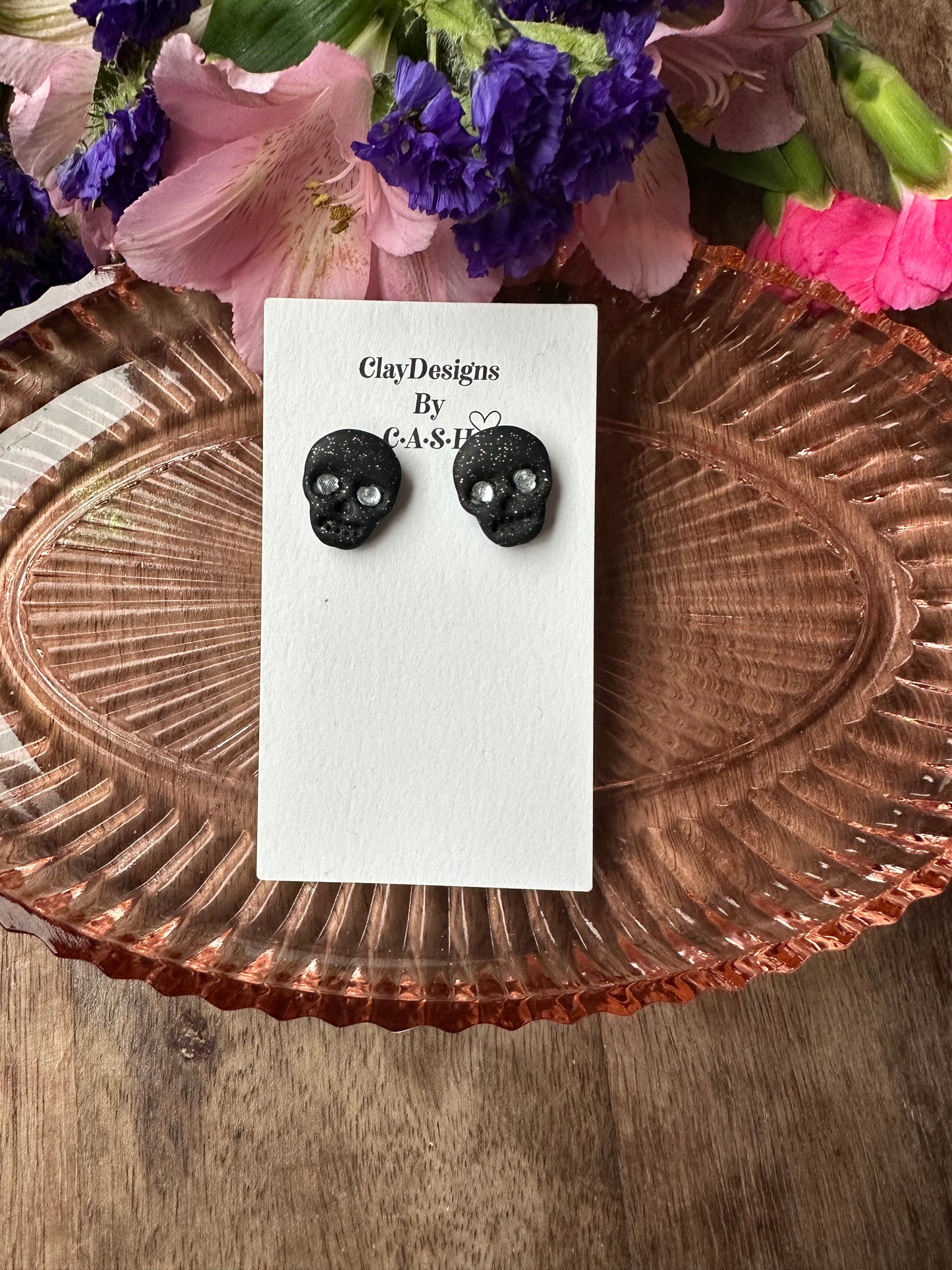 Black glitter skull studs