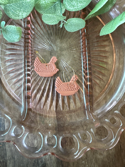 Terra cotta hens on hoops