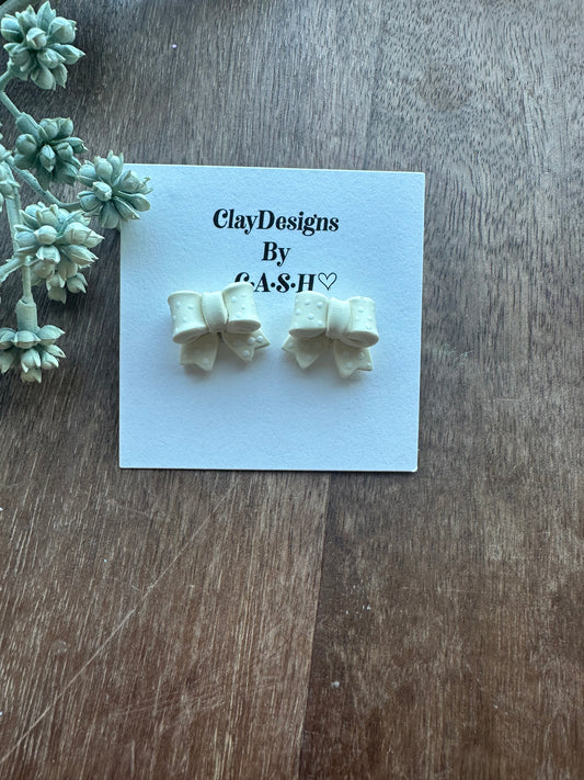 Yellow polka dot bow studs